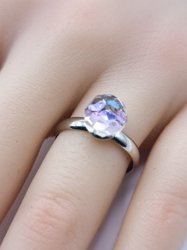 An elegant adjustable ring featuring a brilliantly faceted Czech Republic crystal in blue purple hue. Its radiant sparkle and comfortable fit make it the perfect statement piece for any occasion.