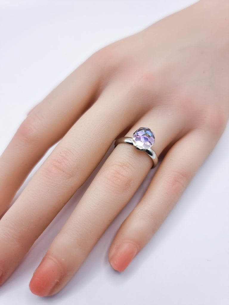 An elegant adjustable ring featuring a brilliantly faceted Czech Republic crystal in blue purple hue. Its radiant sparkle and comfortable fit make it the perfect statement piece for any occasion.