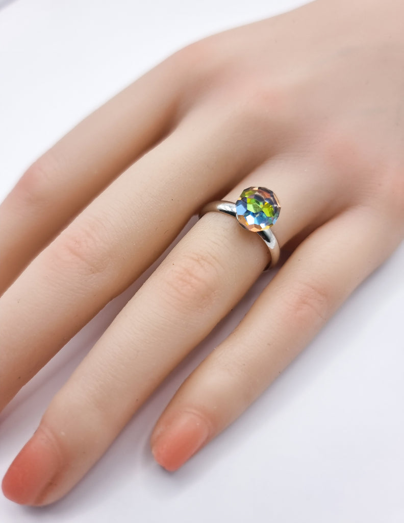 An elegant adjustable ring featuring a brilliantly faceted Czech Republic crystal in vibrant rainbow hues. Its radiant sparkle and comfortable fit make it the perfect statement piece for any occasion.