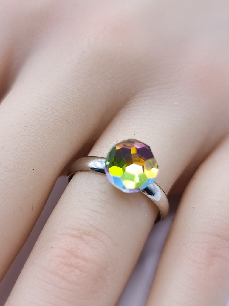 An elegant adjustable ring featuring a brilliantly faceted Czech Republic crystal in vibrant rainbow hues. Its radiant sparkle and comfortable fit make it the perfect statement piece for any occasion.