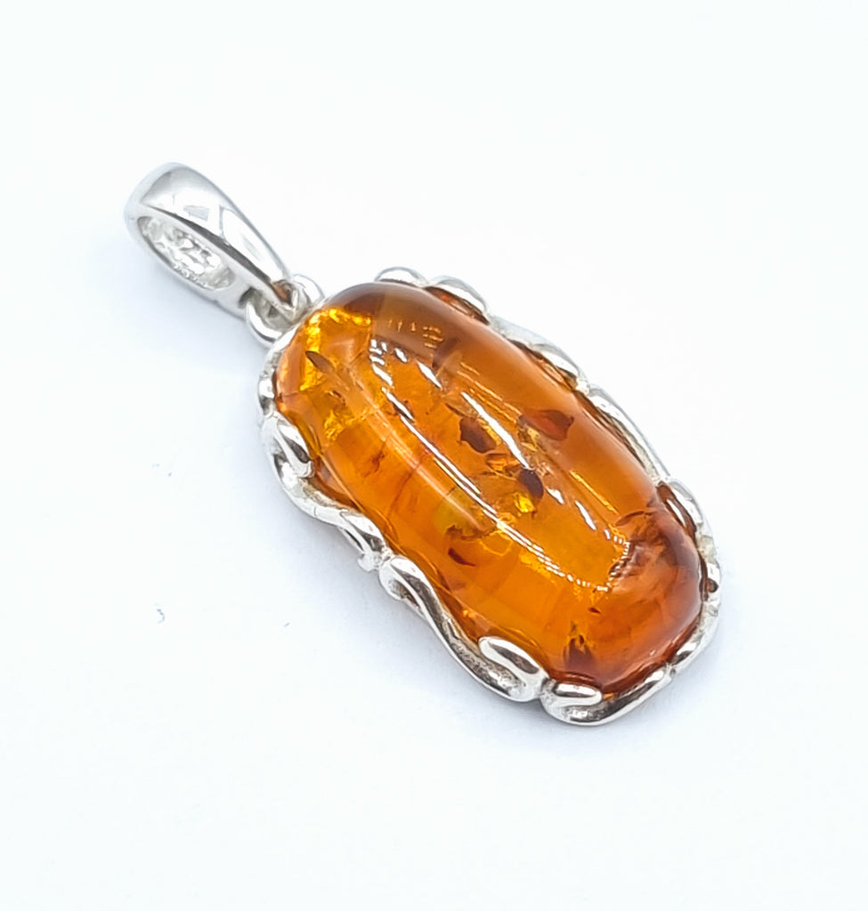 Oval cognac natural Baltic Amber pendant set on a Sterling Silver decorative frame