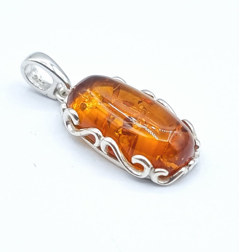 Oval cognac natural Baltic Amber pendant set on a Sterling Silver decorative frame