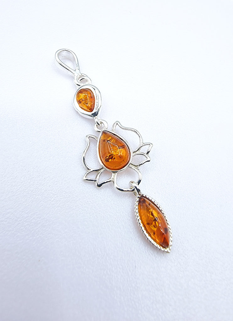 A beautiful pendant crafted with natural cognac Baltic Amber on Sterling Silver, with a beautiful Lotus centre accent. 