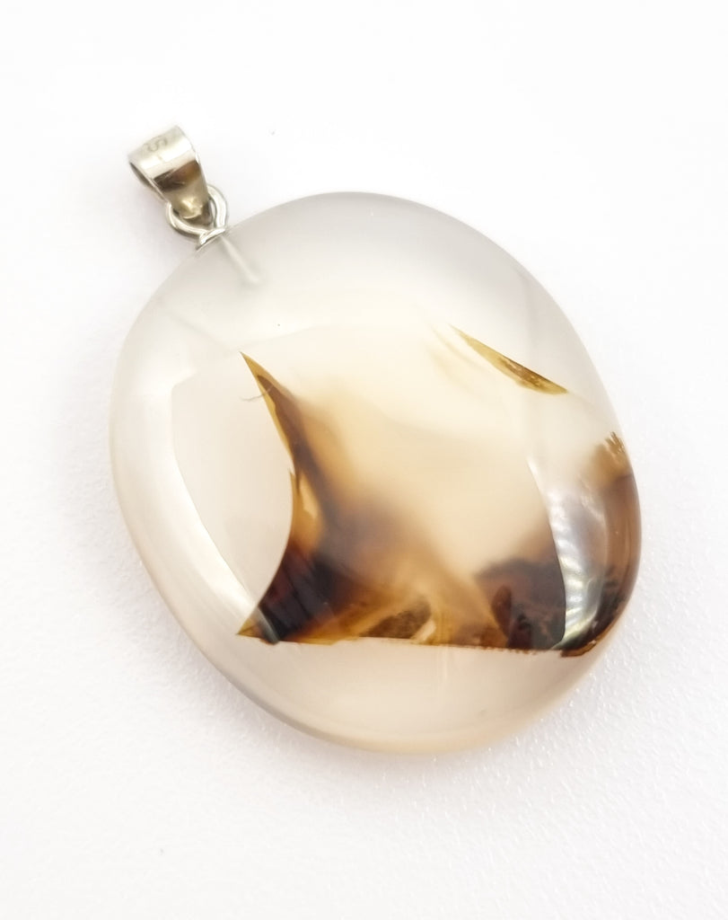 A unique natural dendritic landscape agate pendant featuring inclusions in abstract form creating unique shapes providing with endless possibilities for imagination. Completed with a tiny 925 Sterling Silver bail, this is a beautiful, elegant piece of jewelry.