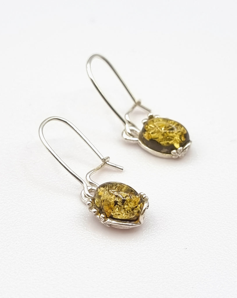 A pair of exquisite drop earrings, crafted from 925 Sterling Silver and featuring luxurious, natural Baltic Amber stones. Set on 925 Sterling Silver kidney hooks, the Amber stones are beautifully exposed. Origin Poland