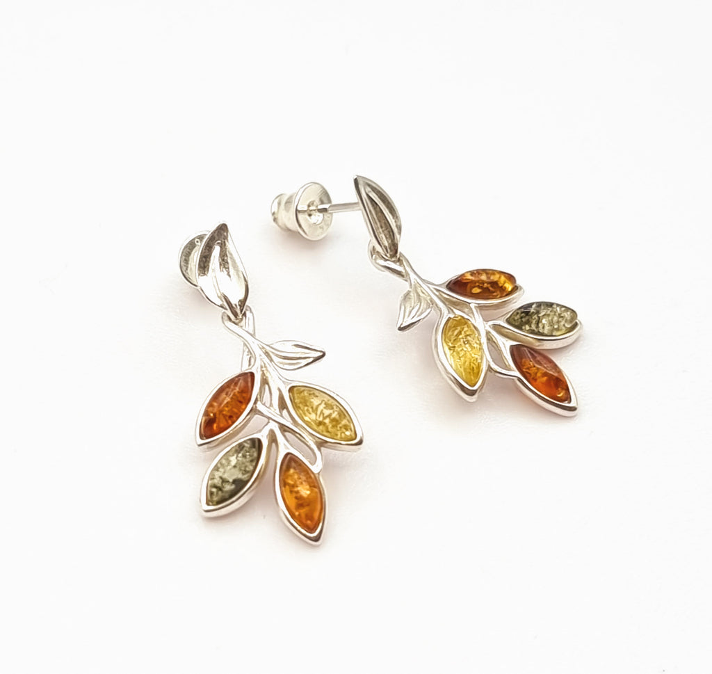 Shaped like a beautiful vine drop, these pair of captivating dangling earrings are crafted on 925 sterling silver with natural Baltic Amber in shades of cognac, light yellow and green. Origin Poland