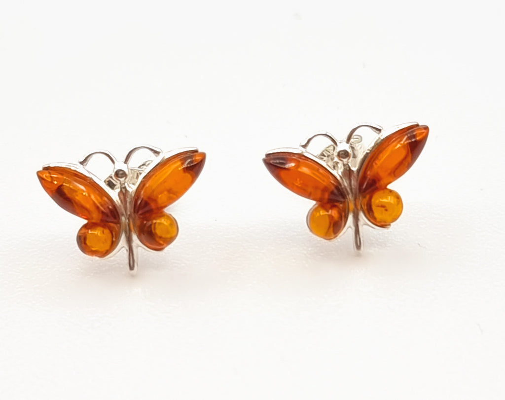 A pair of elegant nature-inspired tiny butterfly Baltic Amber stud earrings are the perfect accessory for nature lovers. Crafted with Sterling Silver and natural cognac Amber, these studs are sure to become a treasured accessory. Origin Poland