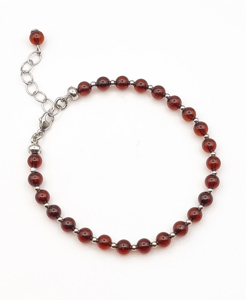 A classic style elegant beaded bracelet, crafted from natural Baltic Amber in cherry red tones, and 925 Sterling Silver. Can be layered with other bracelets or worn by itself for a more classic, understated look. The natural healing properties of Baltic Amber may help reduce anxiety and soothe inflammation. Origin: Poland