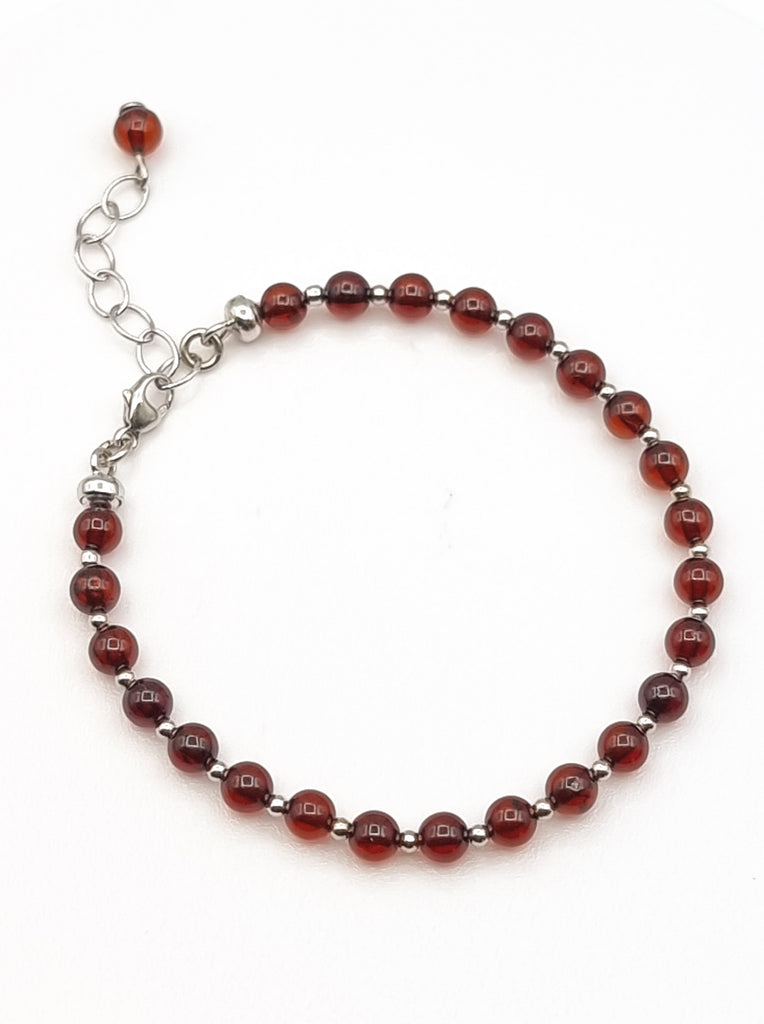 A classic style elegant beaded bracelet, crafted from natural Baltic Amber in cherry red tones, and 925 Sterling Silver. Can be layered with other bracelets or worn by itself for a more classic, understated look. The natural healing properties of Baltic Amber may help reduce anxiety and soothe inflammation. Origin: Poland