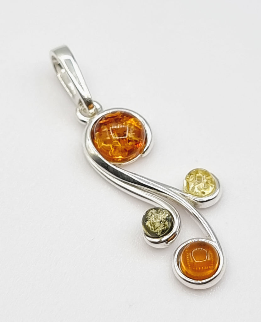 An elegant pendant, crafted with natural Baltic Amber on 925 Sterling Silver. A sophisticated design, created with 3 tones of beautiful Amber, in hues of green, light yellow and cognac. With a modern swirl pattern, this pendant will look truly gorgeous as a necklace. Perfect for women. Origin Poland