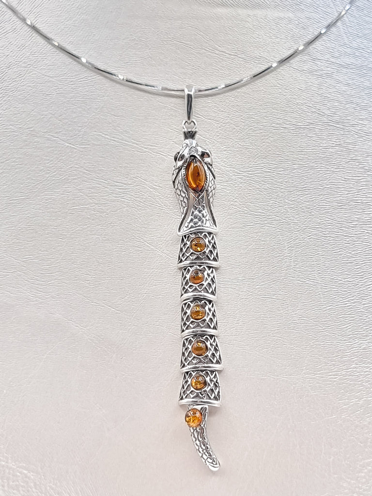 A gorgeous pendant, crafted and intricately carved on Sterling Silver and set with shimmering natural cognac Baltic Amber gemstones. This unique ‘Snake’ necklace is a beautiful creation that is alluring. The flexible links and intricate carving make the design unique, chic, and elegant. Perfect necklace for the fashionable woman! Origin Poland