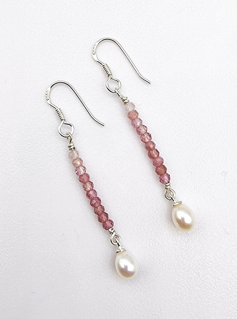 Offering a drop of pink hues, with these gorgeous natural Pink Tourmaline earrings, gracefully designed with drops of white lustrous Freshwater Pearls on Sterling Silver. These exquisite natural gems add a touch of elegance and sophistication to any feminine beauty. Perfect for expressing your love, these luxurious earrings are a gorgeous gift of love.