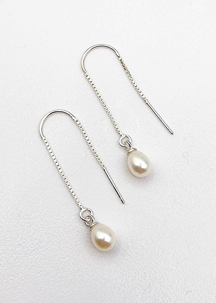 A pair of gorgeous drop earrings handmade and delicately designed with sterling silver thread and needle hook. The white lustrous cultured freshwater pearls make these earrings truly gorgeous and exquisite