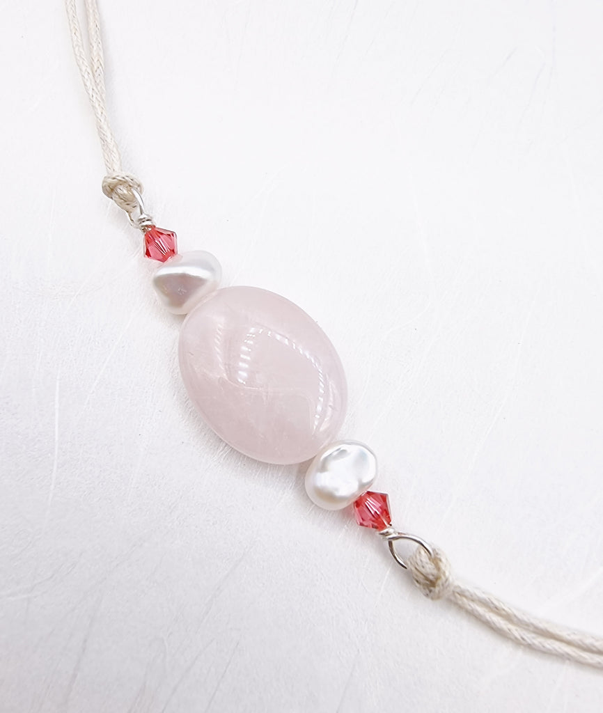 A handmade Rakhi delicately crafted with a beautiful natural Rose Quartz gemstone and lustrous white freshwater baroque Pearls, symbolising love and harmony. Truly unique and one-of-a-kind!