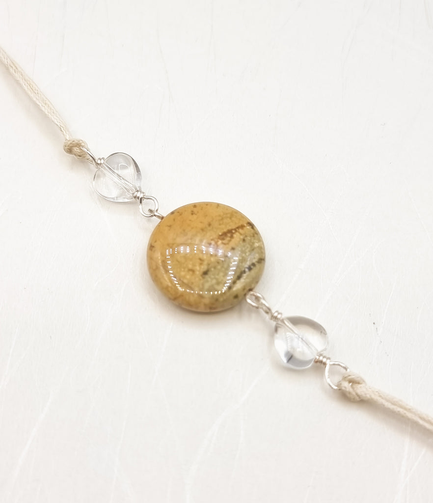 A handmade Rakhi delicately crafted with a charming natural Picture Jasper and lustrous Clear Quartz gemstones. Celebrate sibling bond with this unique and meaningful handmade Rakhi. Truly unique and one-of-a-kind!