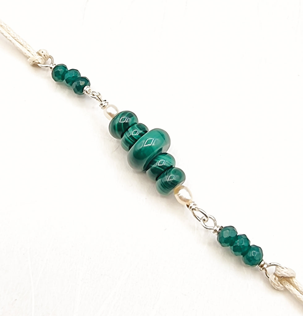 A handmade Rakhi delicately crafted with beautiful natural Malachite gemstones in a vivid hue of green, with tiny Freshwater Pearl accent. The colour green represents hope and optimism, harmony and balance. Truly unique and one-of-a-kind!