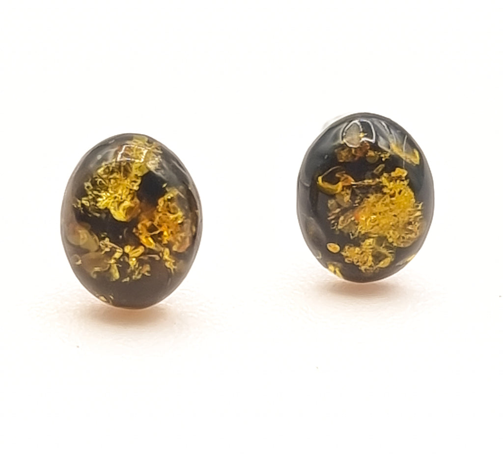 A pair of beautiful green natural Baltic Amber stud earrings, set on 925 Sterling Silver posts. The stunning Amber cabochon reflects gorgeous inclusions that shimmer like gold, adding a luxurious touch. Origin Poland