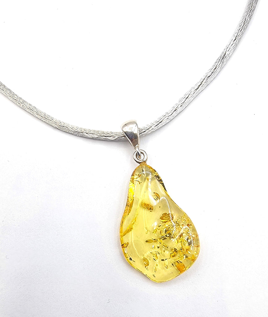 A beautiful citrine freeform natural Baltic Amber pendant crafted with a sterling silver bail. It is a unique piece, with vibrant hues and a freeform shape. Truly one of a kind and gorgeous. Origin Poland