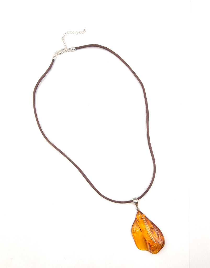 This exquisite freeform pendant is crafted from natural Baltic Amber, accentuated with a Sterling Silver bail. Its beautiful and unusual design reveals the inclusions and the natural form of the cognac Amber perfectly. Truly unique. Origin Poland