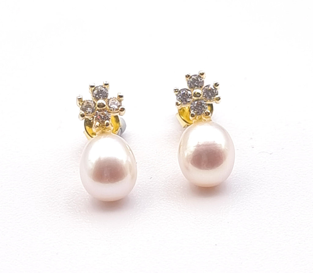 Elevate elegance with these gorgeous Freshwater pearl drop stud earrings. Handpicked for their lustrous white hue with a pink overtone, these beautiful Freshwater pearls are designed on lovely gold-plated sterling silver floral studs, adorned with cubic zirconia, that brings sophistication to any occasion – perfect for mornings or evenings.