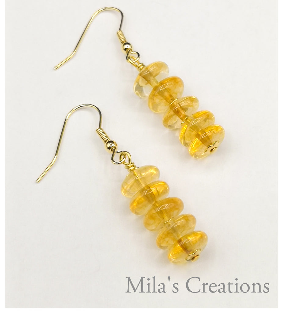 A pair of gorgeous high grade Citrine rondell handmade drop earrings add a vibrant glow on a bright sunny morning.