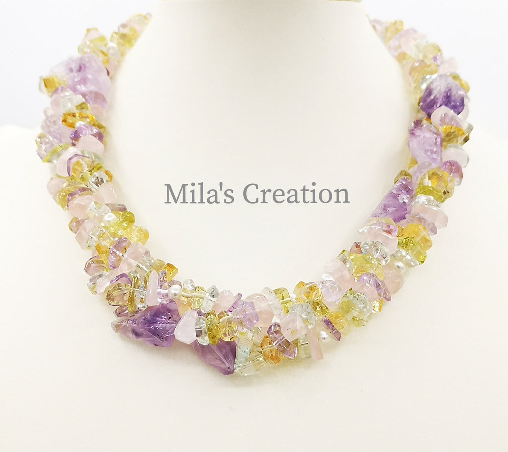 A Torsade style handmade Necklace designed with soft hues of a variety of Quartz - Citrine, Amethyst, Green Amethyst, Lemon Quartz, Rose Quartz and Freshwater Pearls. The necklace can be worn in a loose three strand look or in a twisted fashion.