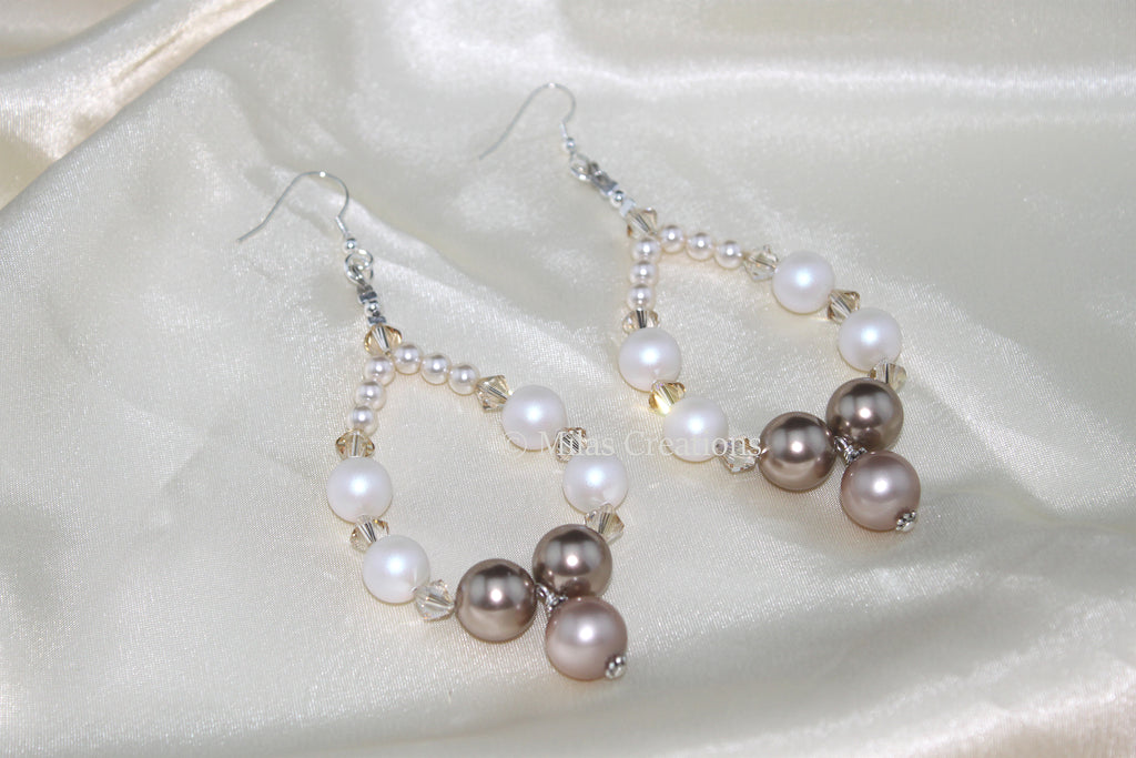 A pair of handwoven danglers designed with Swarovski Pearls and Crystals in Almond and Cream tones, add a touch of style and elegance.