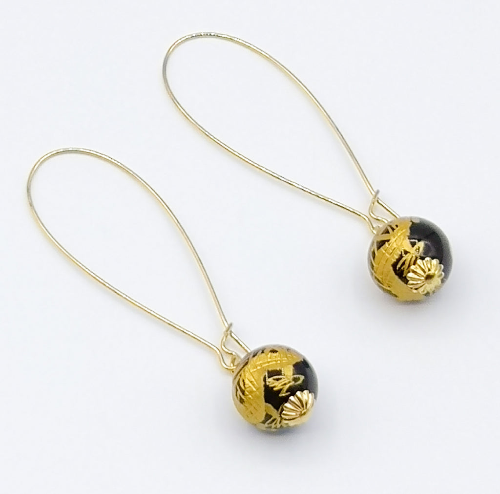 A pair of beautiful handmade Onyx drop earrings carved with golden Chinese Dragons, which is believed to be a symbol of power, strength and good luck. Designed on gold plated stainless steel kidney hooks