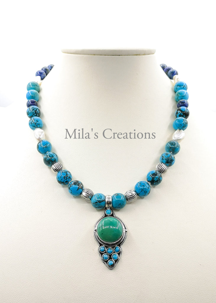 A beautiful handmade necklace and earring set designed with a combination of stabilised Turquoise and Azurite with lustrous Baroque Pearls. With a simple yet elegant Sterling Silver pendant, encrusted with turquoise makes this piece a one of a kind